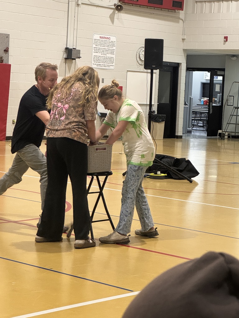2 students and the speaker digging for letters for the fishing pole. 