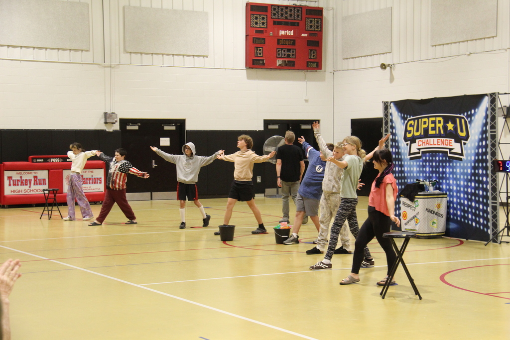 8 students doing their super hero pose after the competition. 