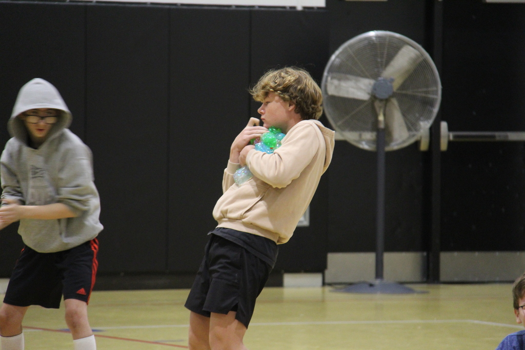 One of the students holding all the squishies that students handed him in a competition to hold the most. 