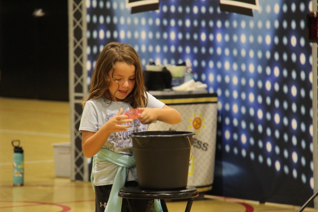 Student getting ready to pass the squishy on to the next student in a competition. 