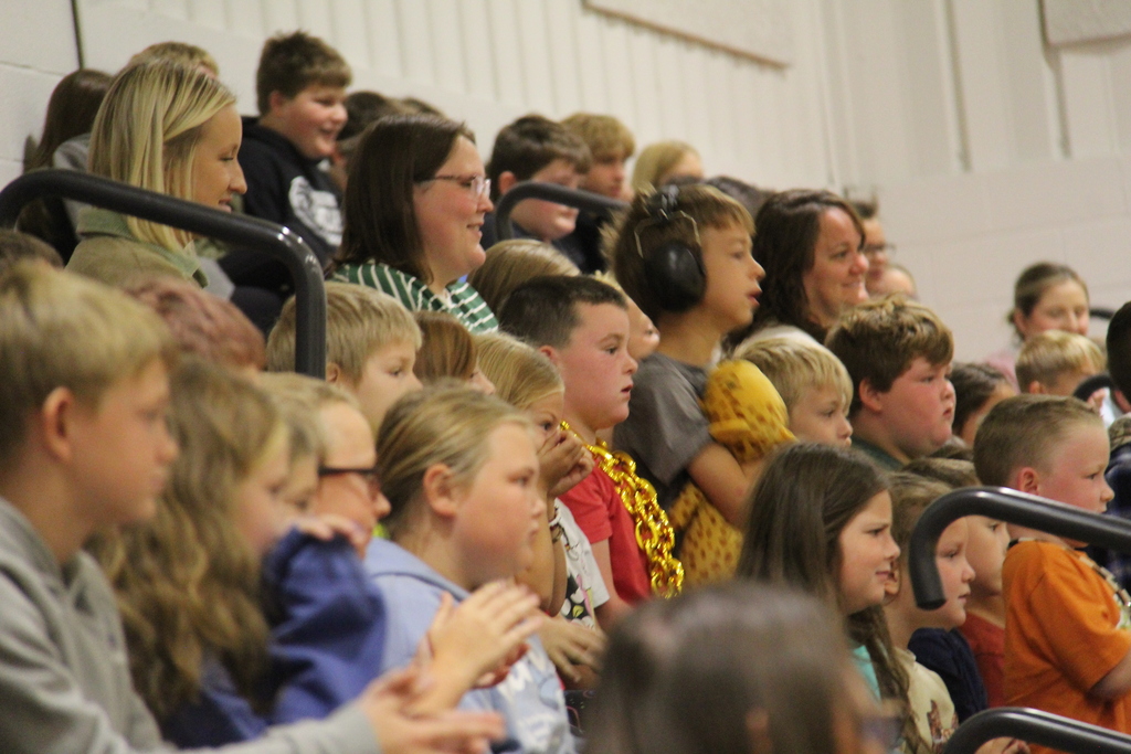 Students sitting on the bleachers listening to the speaker at the Super U Convocation. 