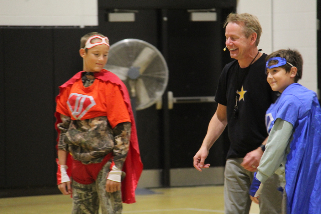 Students with their super hero gear after a race to get their costumes on with the speaker.