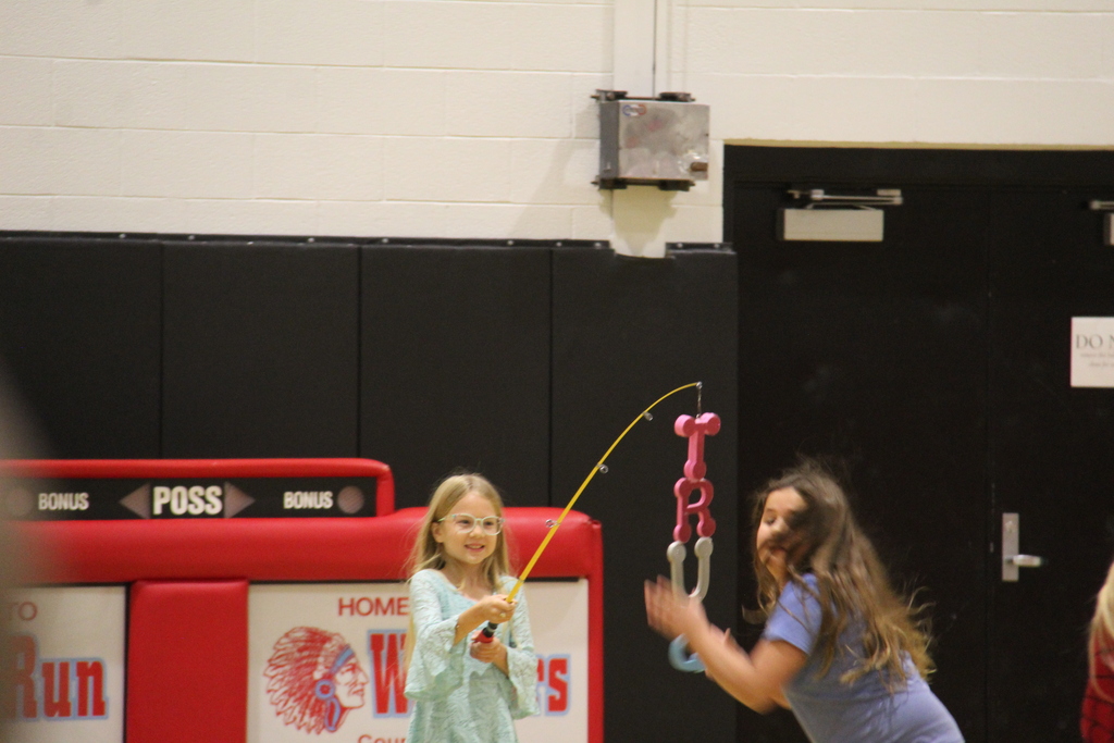 Student adding an S to the fishing pole. 
