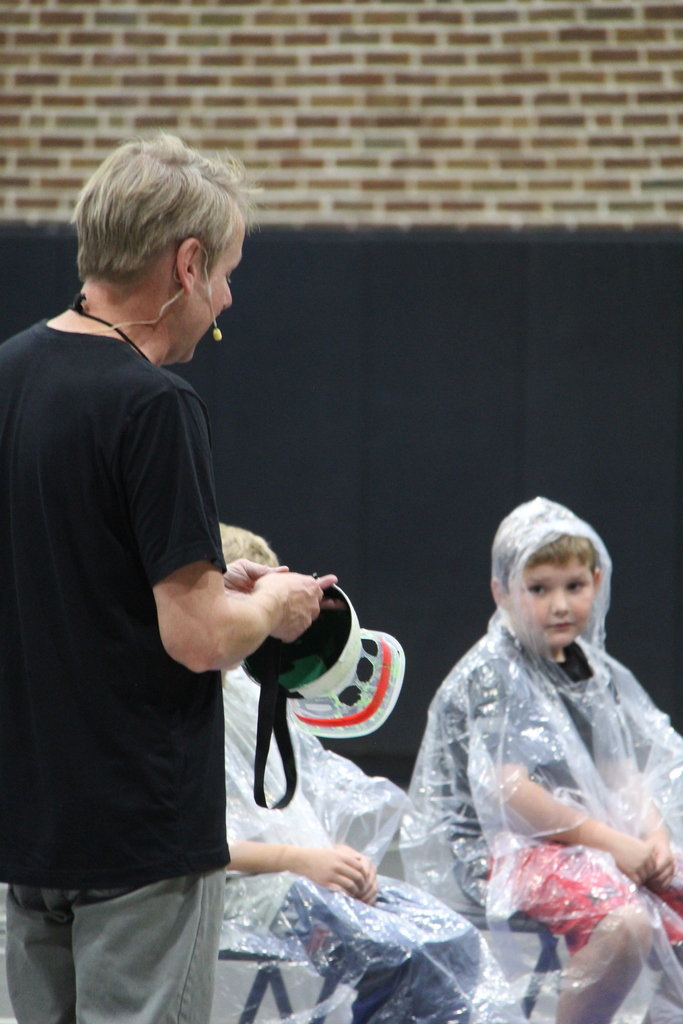 Speaker adjusting the hand made bowl hat to be used for the slime Competition. 