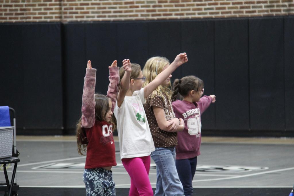 4 students posing after the competion in their best super hero pose. 