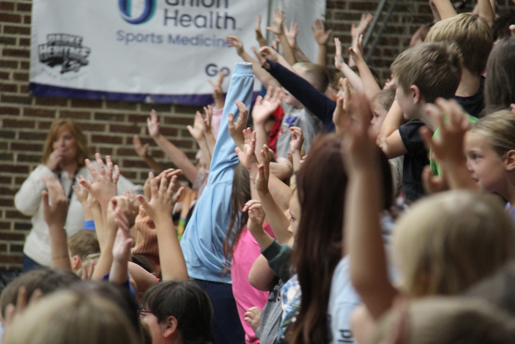 Students raising their hands to be volunteers for the convocation. 
