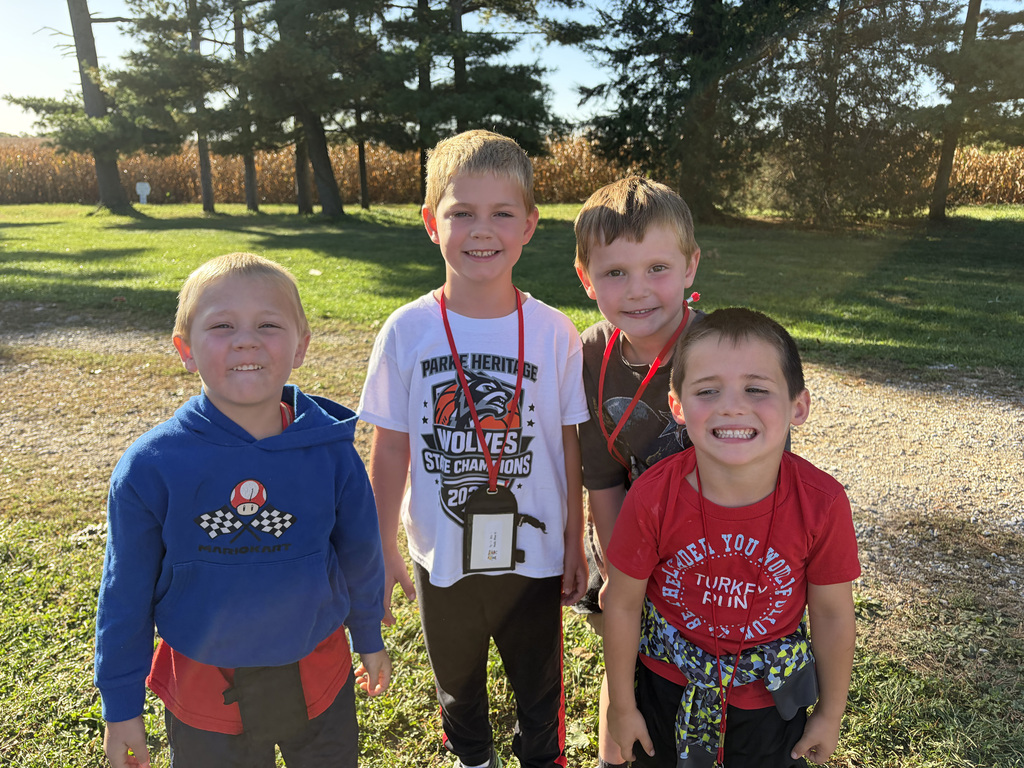 4 kindergarten students pose for a photo. 