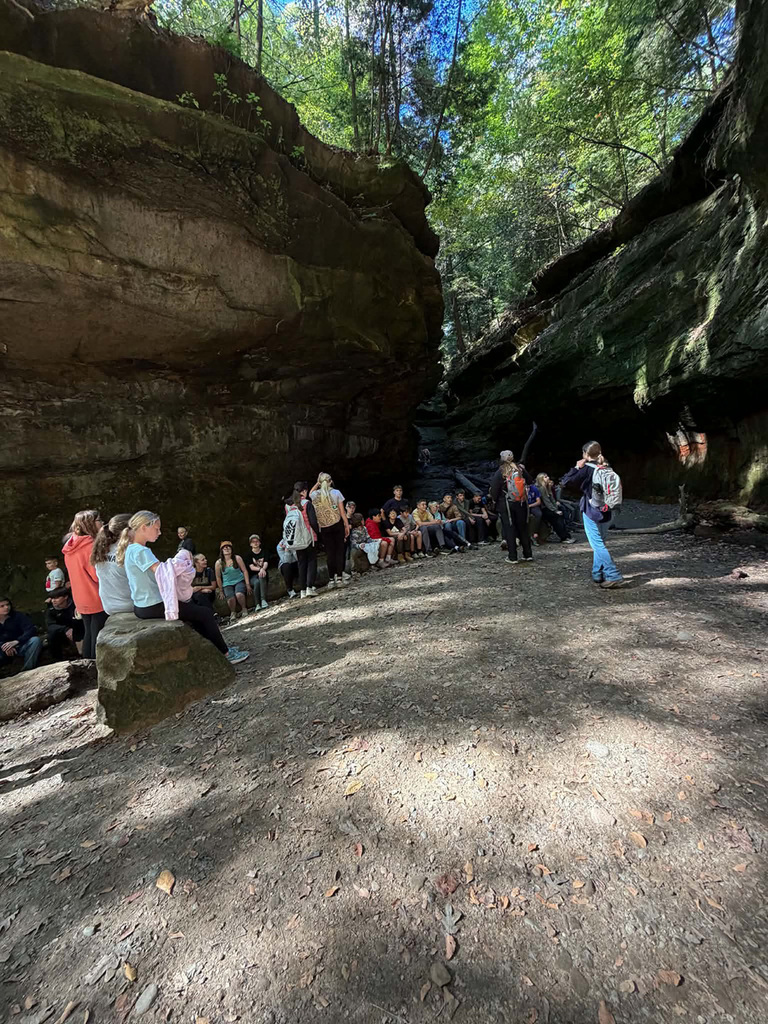Students gathered around with Rocky Hollow surrounding them. 
