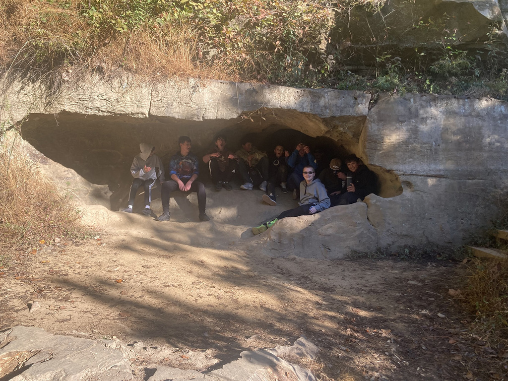Students tucked back inside a cave on the Rocky Hollow path. 