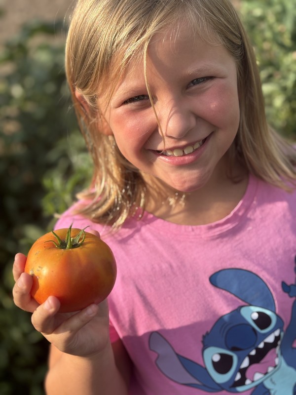 girl holding a tomato