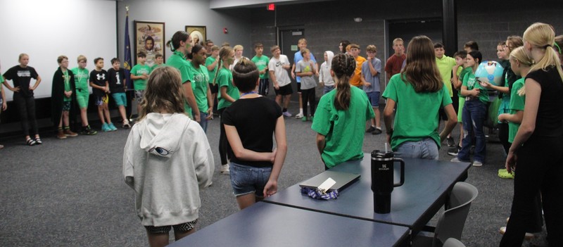 students standing in a circle playing a game