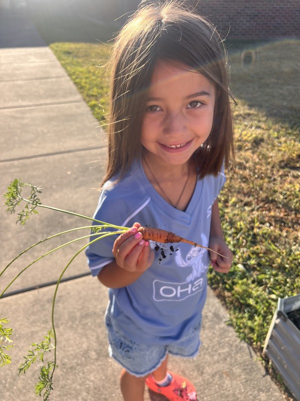 girl holding a carrot