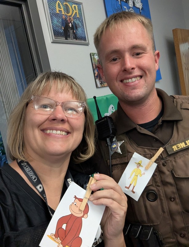 two teachers holding photos