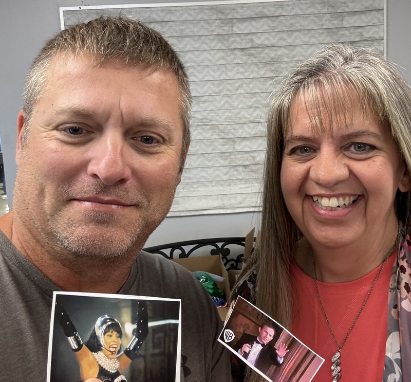 two teachers holding photos