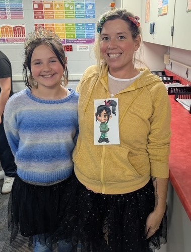 photo of a teacher and a student standing side by side