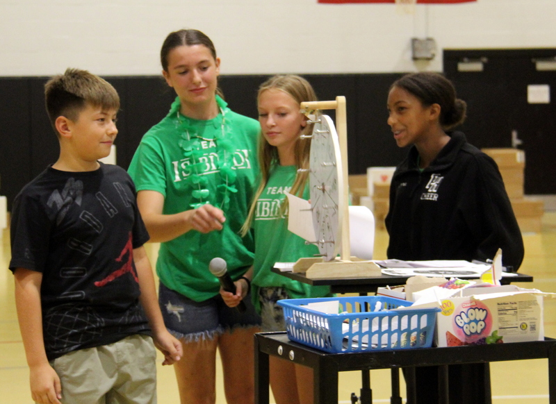 four students standing together in the gym