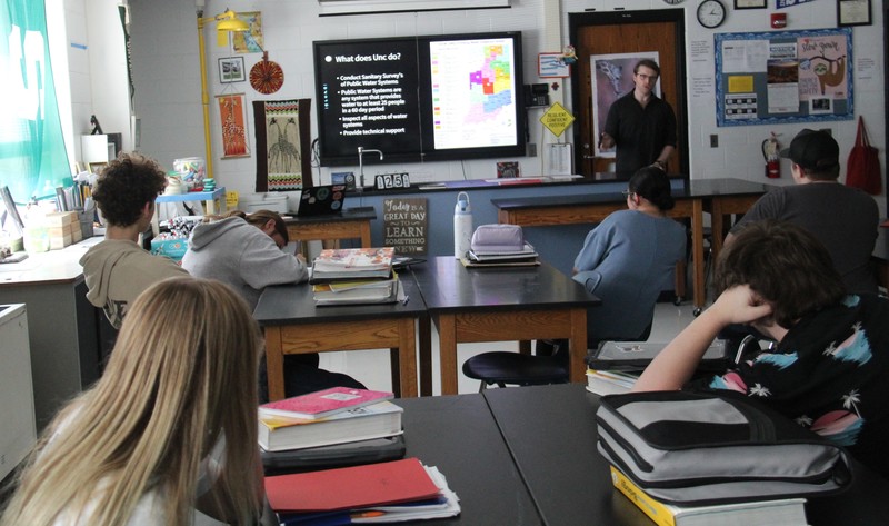 guest speaker with students sitting at their tables