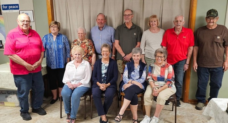 a group of alumni sitting and standing togeher