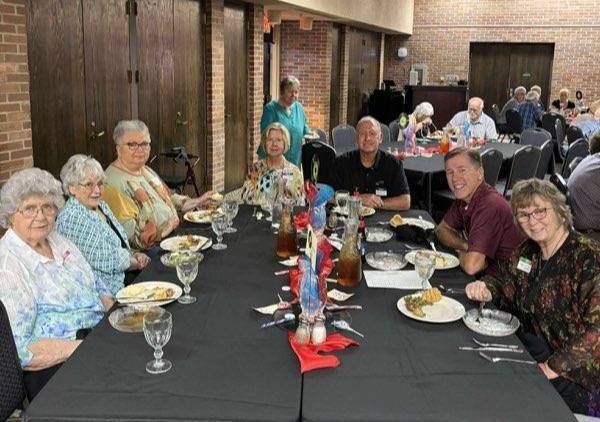 a group of people sitting around a table