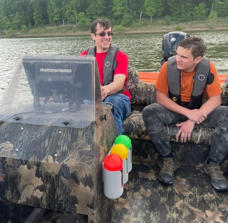 two men on a boat wearing life jackets
