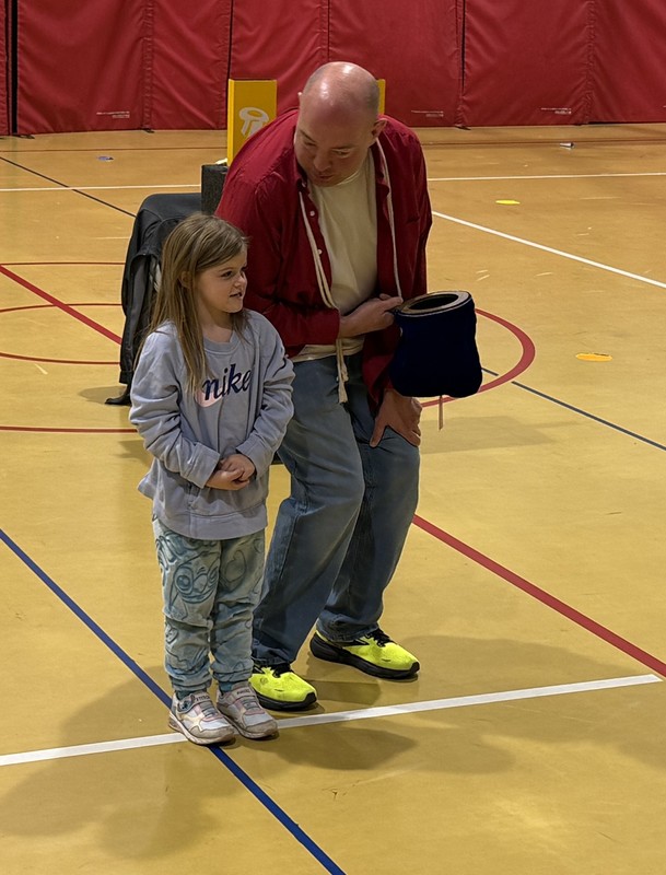 a student standing with a magician