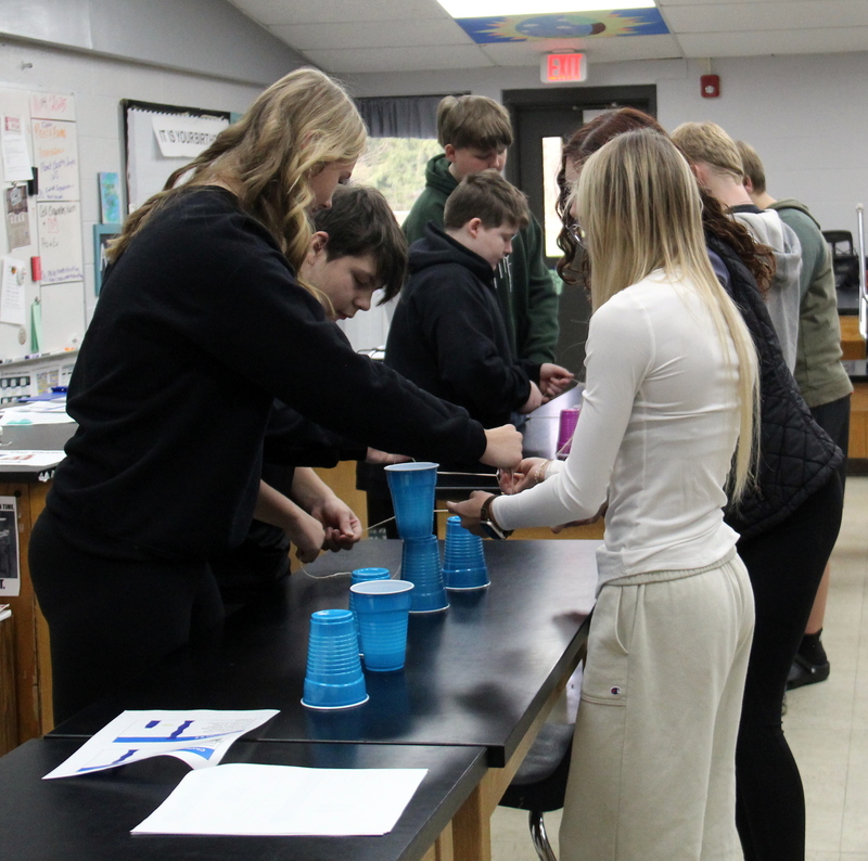 students participating in the cup stacking station