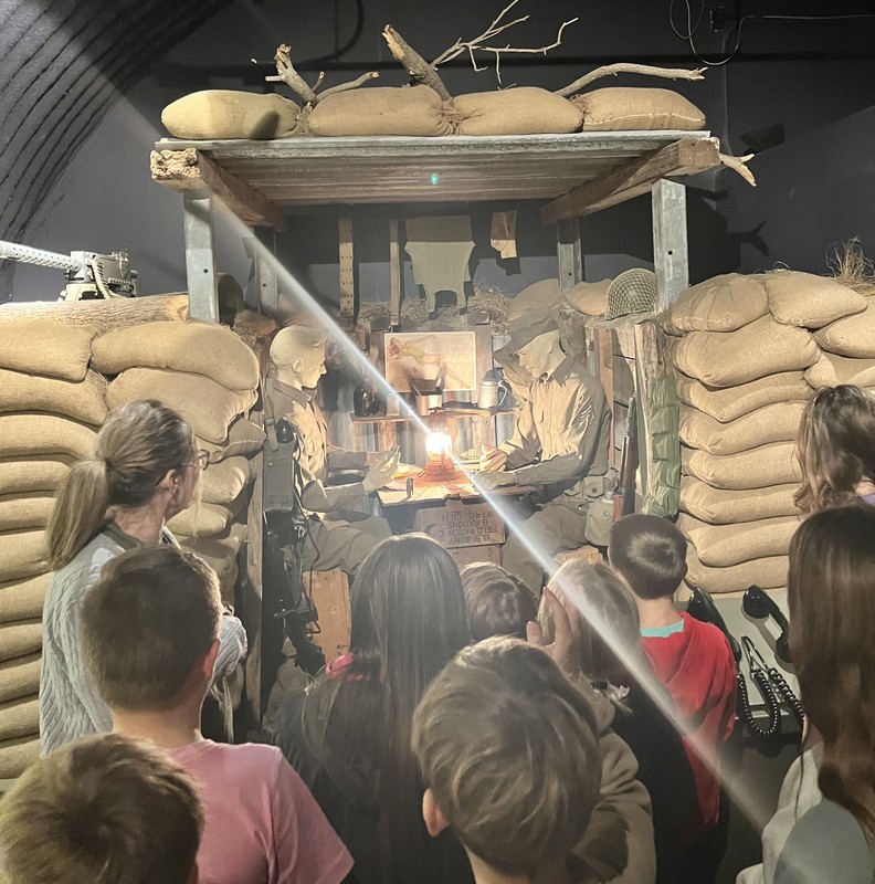 students listening to a video inside the Ernie Pyle Museum