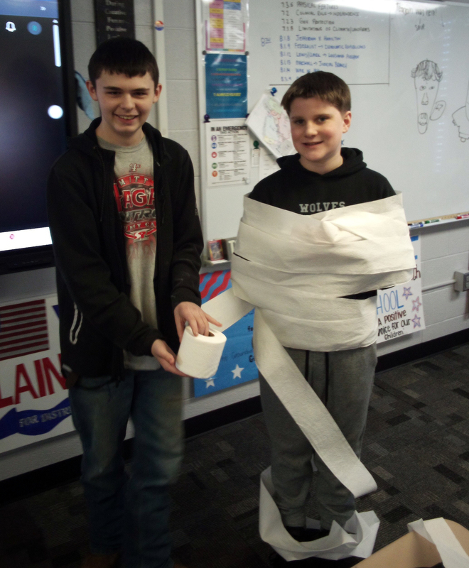 a student wrapping another student in toilet paper