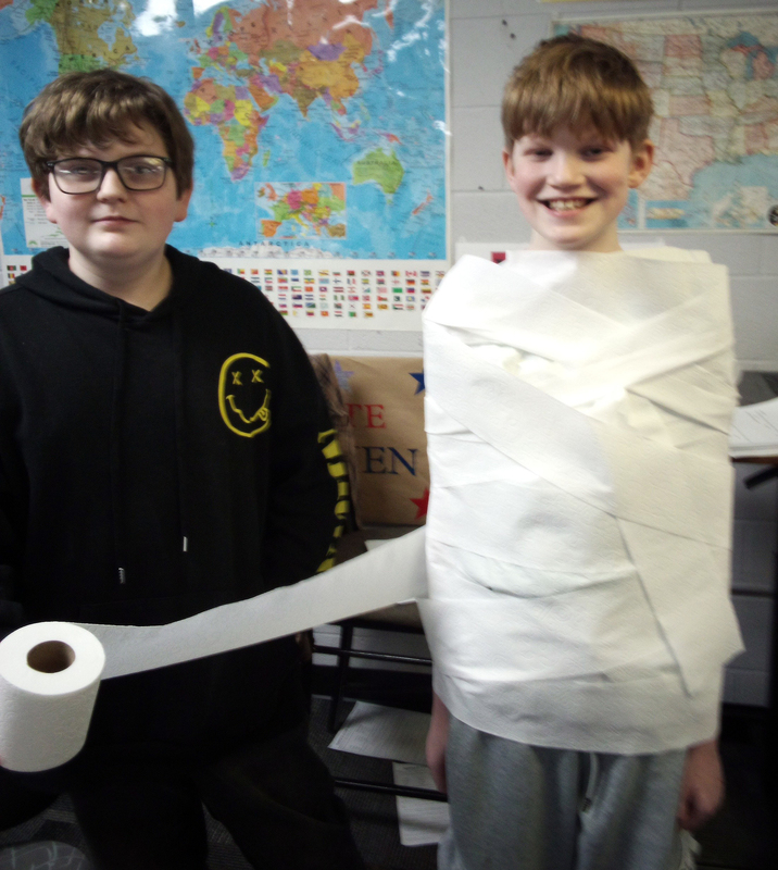 a student wrapping another student in toilet paper