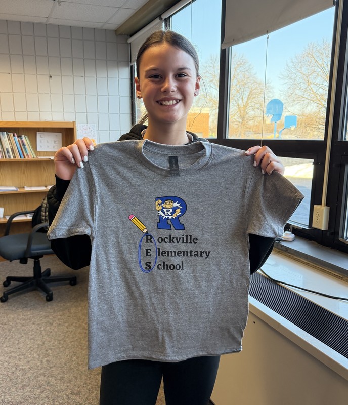 a girl holding the shirt that she designed