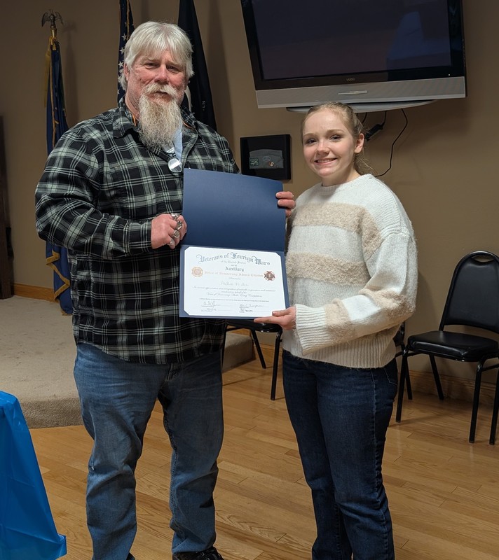 a man presenting a certificate to a female student