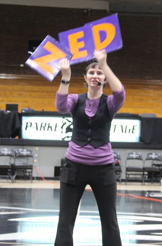 a woman holding signs with the letters NED