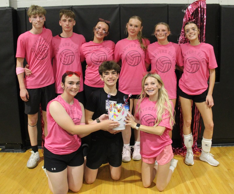 volleyball players sitting or standing in the gym