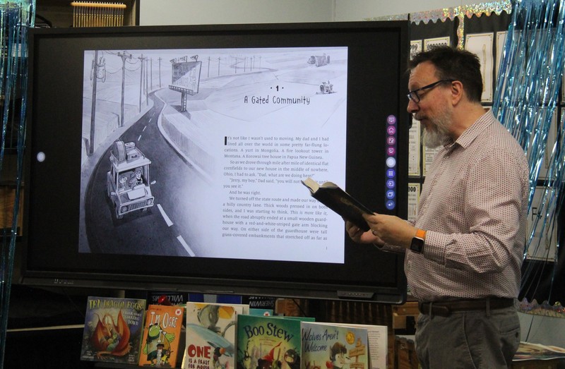 an author reading his book to students
