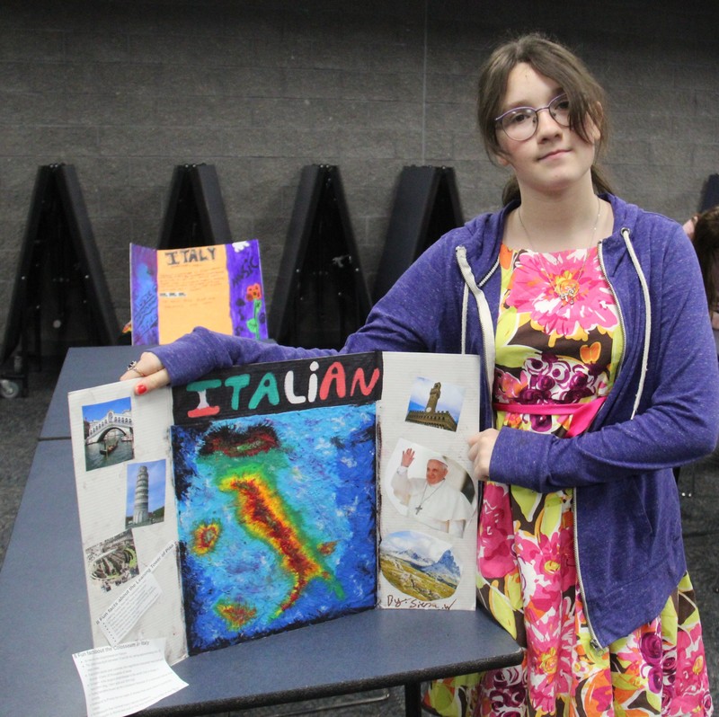 a girl holding her display board on Italy