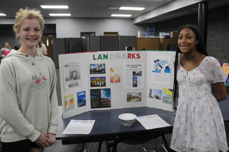 two girls with their display board on Italy between them