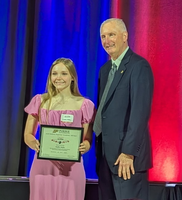 two people with one holding a certificate