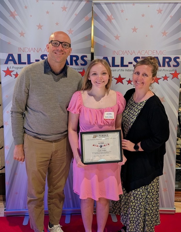 three people with one holding a certificate