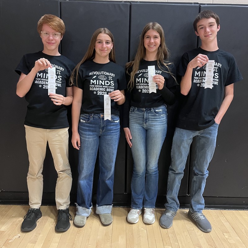 four students standing in a row holding ribbons