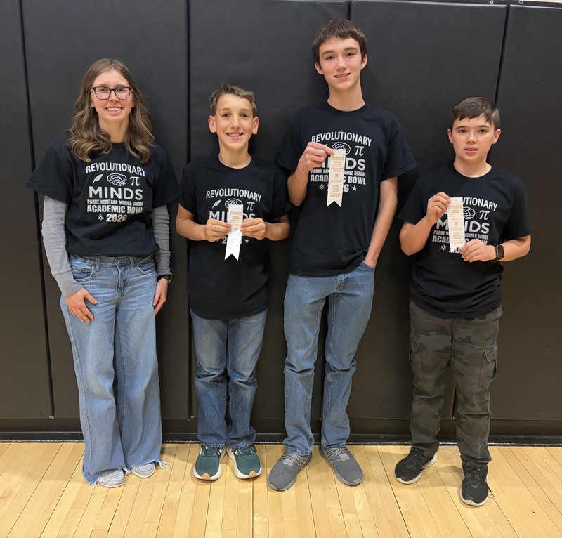 four people standing in a row with three of them holding ribbons