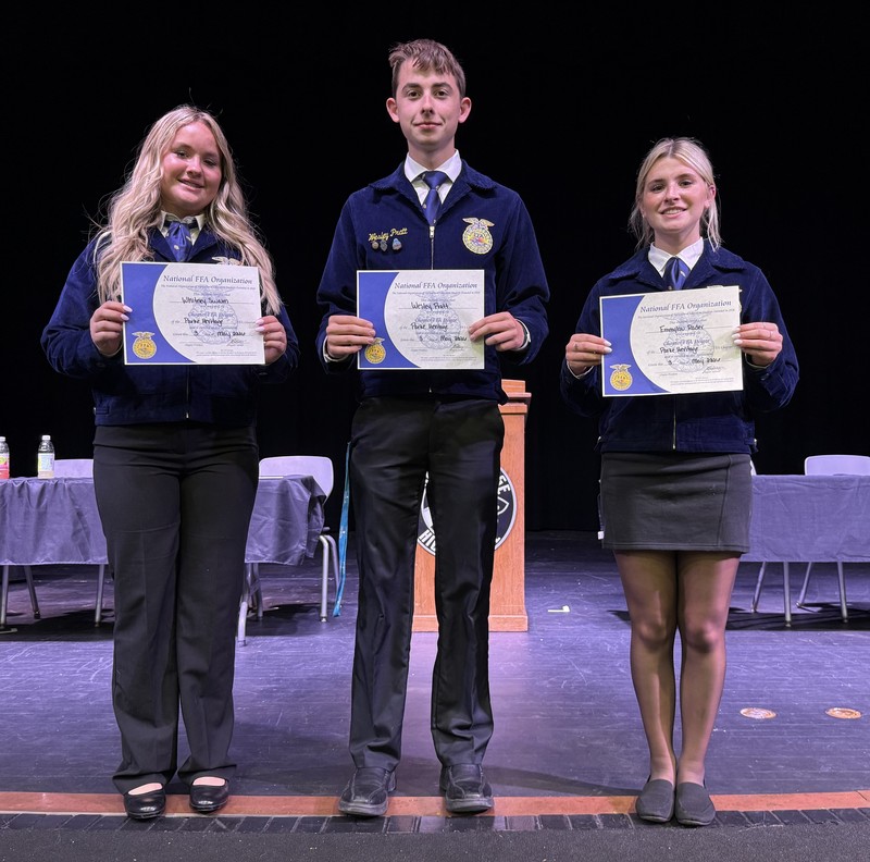 three FFA members standing in a line holding certificates