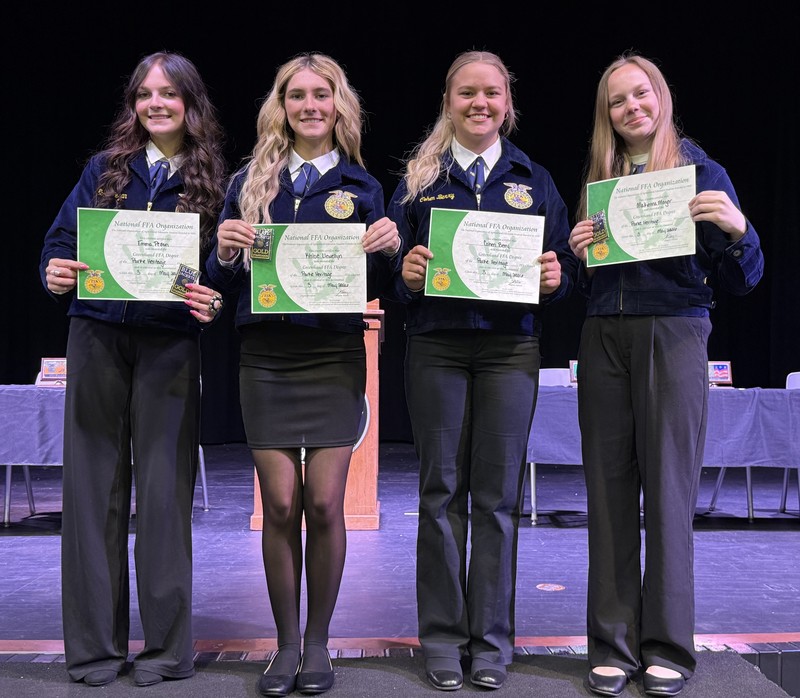 four FFA members standing in a line holding certificates
