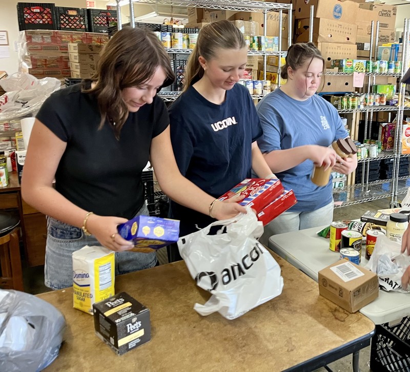 three students sorting food items