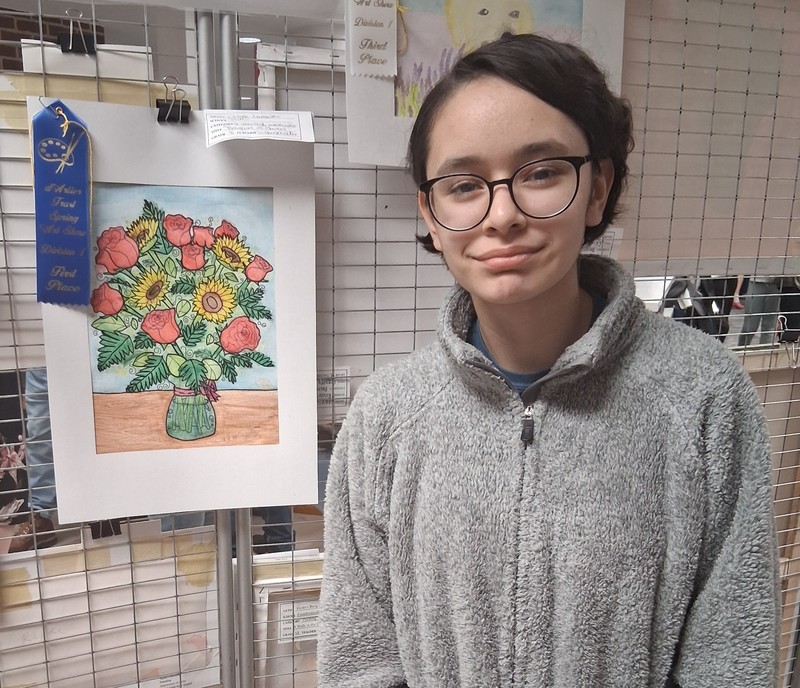photo of a student with her artwork