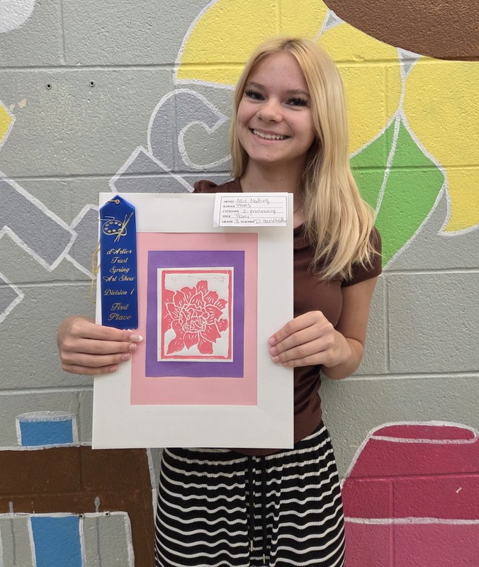 photo of a student with her artwork