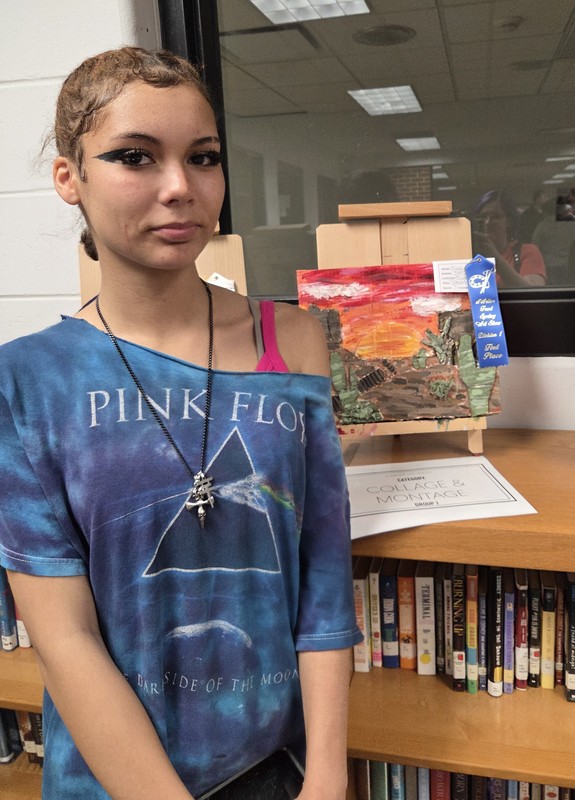 photo of a student with her artwork