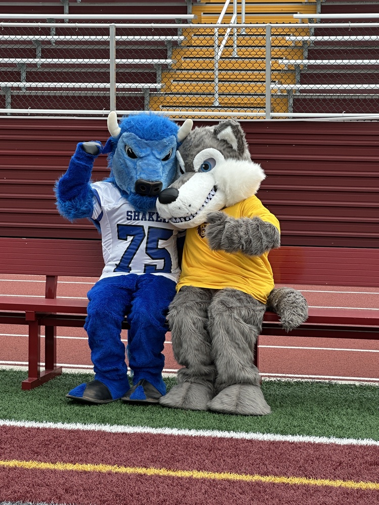 Bryson the Bison and Wolfie from South Colonie sitting on a bench