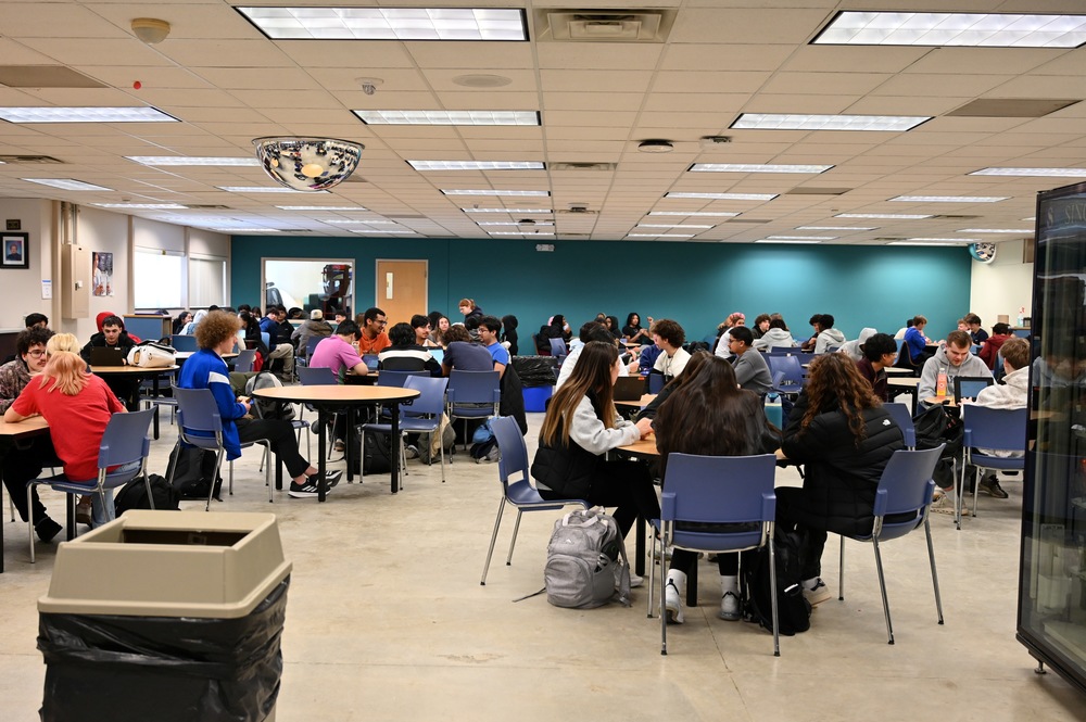 Students sit at lunch tables in the newly established cafeteria.