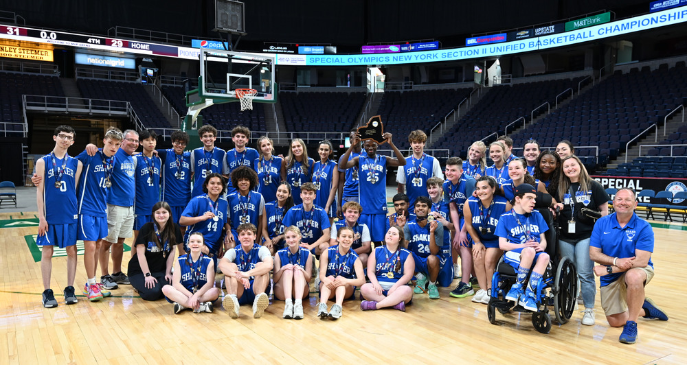 A photograph of the Shaker Unified basketball team after their sectional championship win.
