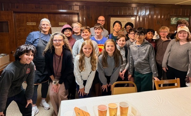group of students standing together posing for a photo in the german american club